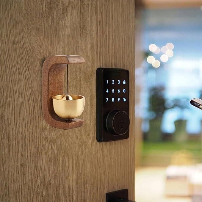 Smart lock on a wooden door with a decorative wooden holder and gold cup.