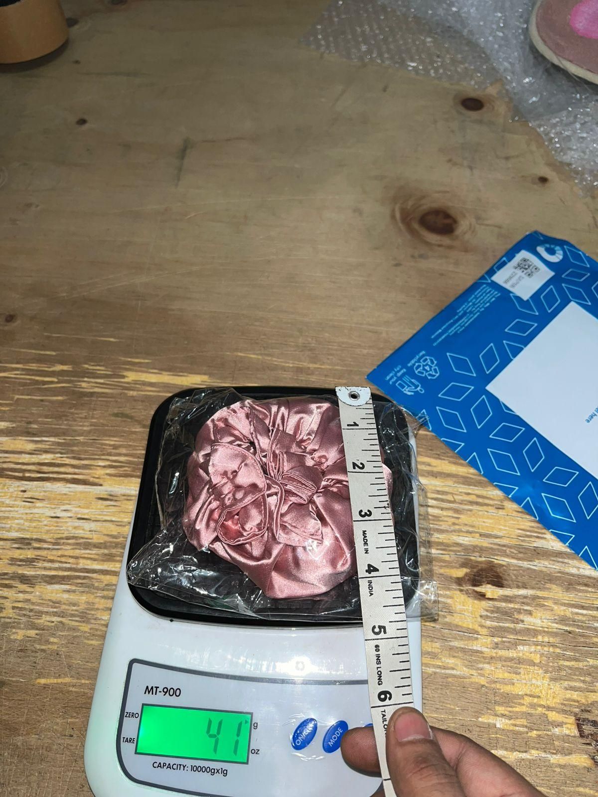 Measuring a package of meat on a digital scale with a ruler