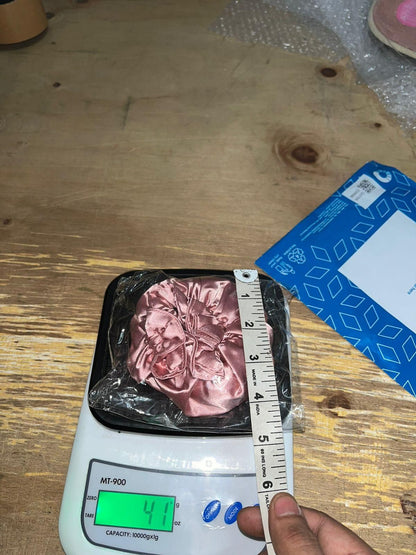 Measuring a package of meat on a digital scale with a ruler